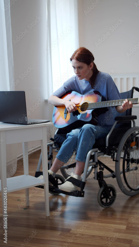 A disabled lady is learning to play the guitar A disabled lady is learning to play the guitar