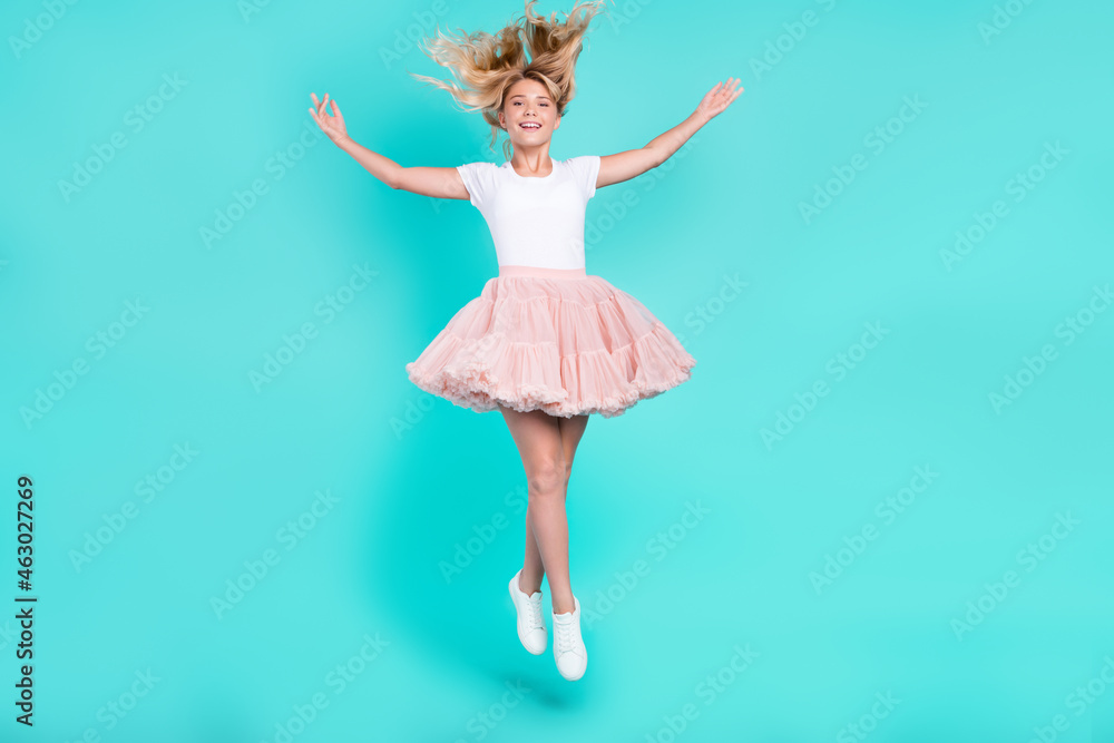 Photo of lovely cute candid lady jump throw hair wear white t-shirt skirt shoes isolated aquamarine color background