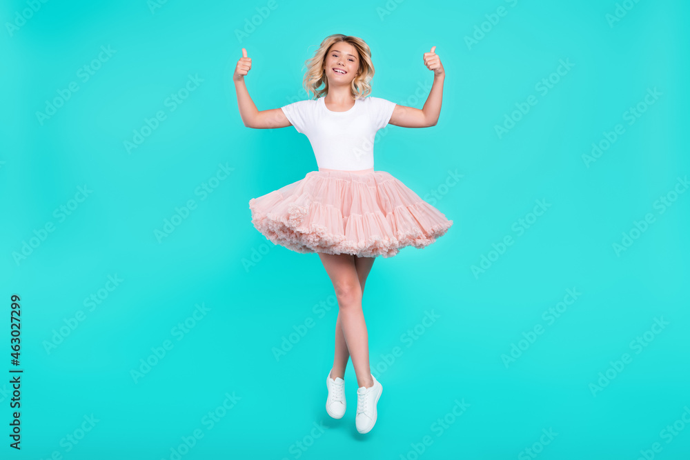 Photo of reliable promoter lady jump show thumb up wear white t-shirt skirt shoes isolated aquamarine color background