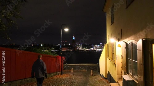 Stockholm, Sweden A man walks on  Monteliusvagen over the Old Town, Gamla Stan, Slussen and Riddarfjarden.  photo