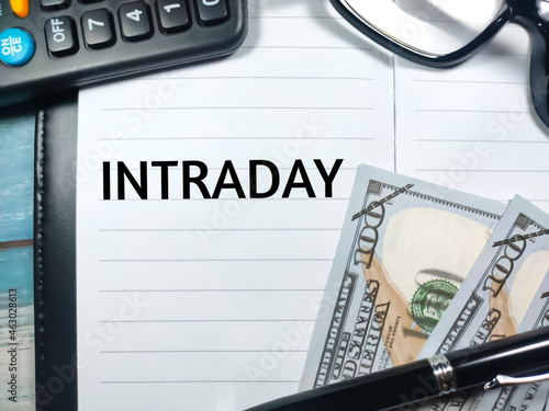 Wallpaper Mural Pen,banknotes,calculator and glasess with word INTRADAY written on notebook.Business concept. Torontodigital.ca