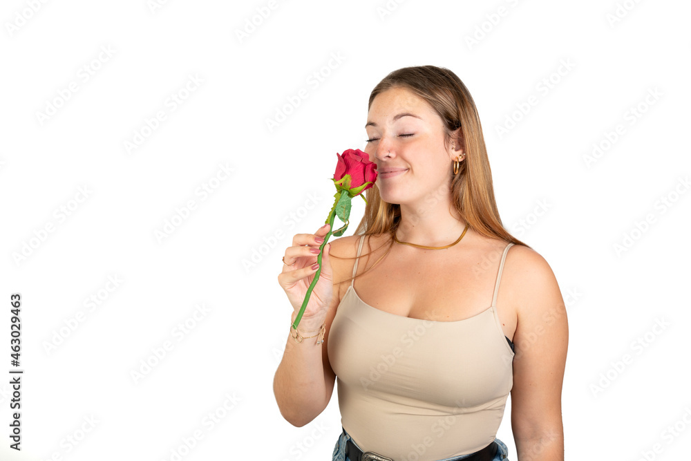 Woman smelling a red rose. 20-22 years old. Isolated on white background. White european woman. Woman smelling a red rose. 20-22 years old. Isolated on white background. White european woman.