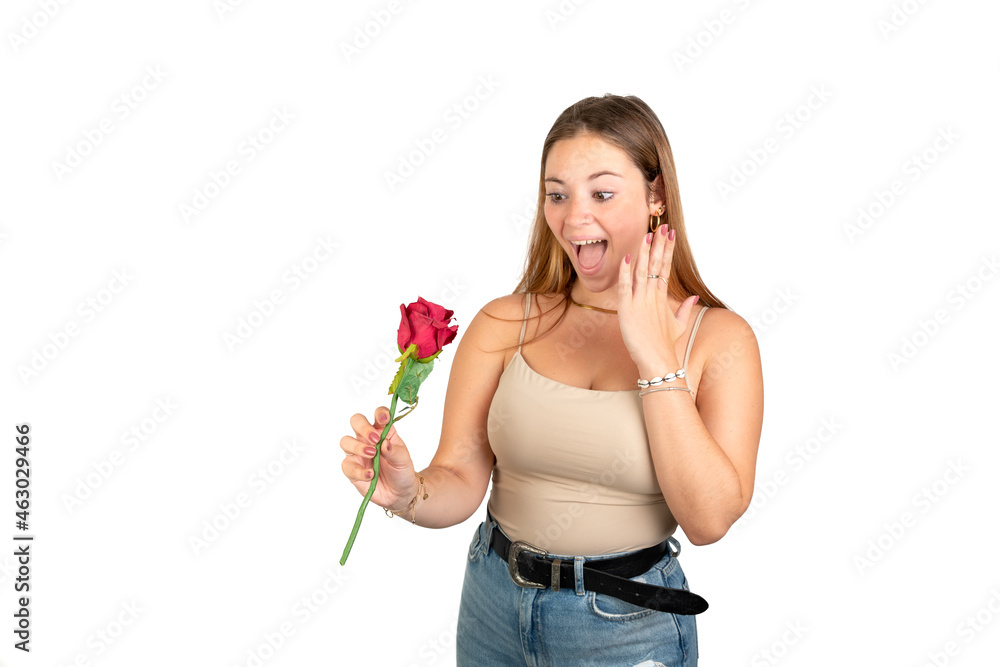 Surprised woman looking a red rose. 20-22 years old. Isolated on white background. White european woman. Surprised woman looking a red rose. 20-22 years old. Isolated on white background. White european woman.