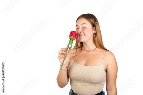 Woman smelling a red rose. 20-22 years old. Isolated on white background. White european woman.