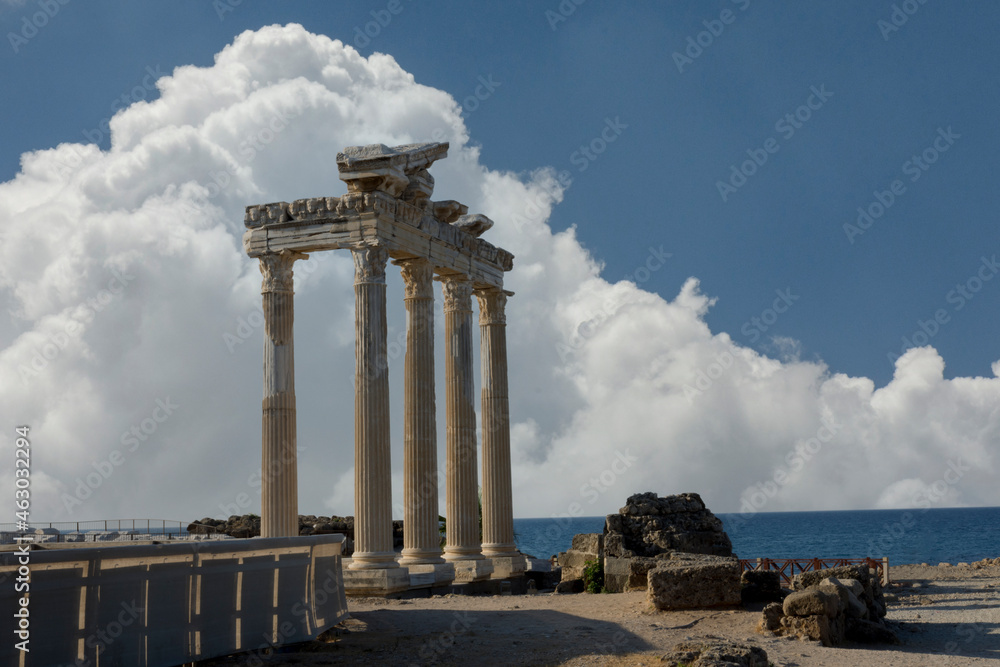Fototapeta premium The Temple of Apollo is a Roman temple built around 150 A.D. on the Mediterranean Sea coast. Side Antalya Turkey. Cloudy Blue Sky. Selective Focus Columns.