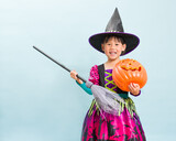 young girl with witch halloween costumes against blue background