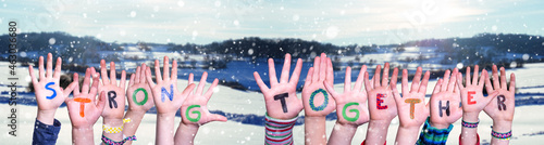 Children Hands Building Word Strong Together, Snowy Winter Background