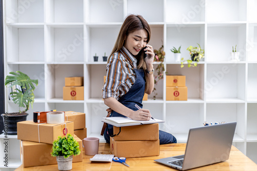 Employees are writing customer shipments to order products through online websites and deliver products through private transportation services. Product sales concepts online. copy space.
