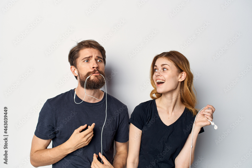 cheerful young couple in black t-shirts phone fun together friendship Studio Lifestyle