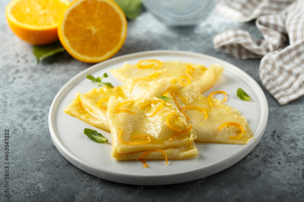 Traditional homemade French pancakes with orange sauce