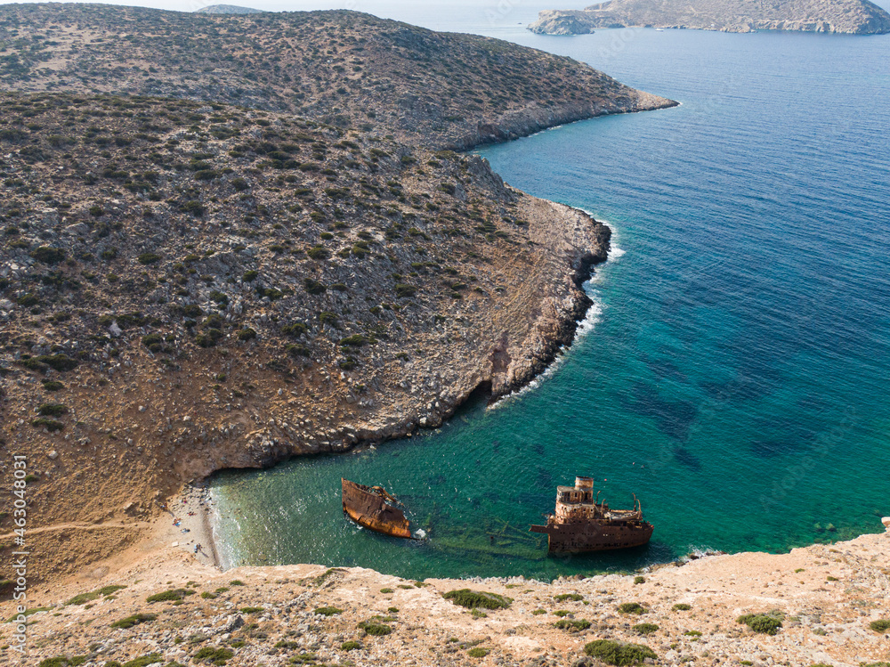 Φωτογραφία aerial drone view of Shipwreck Olympia boat in Amorgos island during summer holidays, at the coastal rocky area, people on the beach, Cyclades, Greece