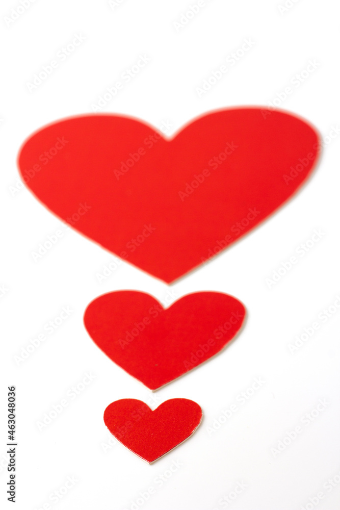 Red heart graded from small to large isolated on a white background.