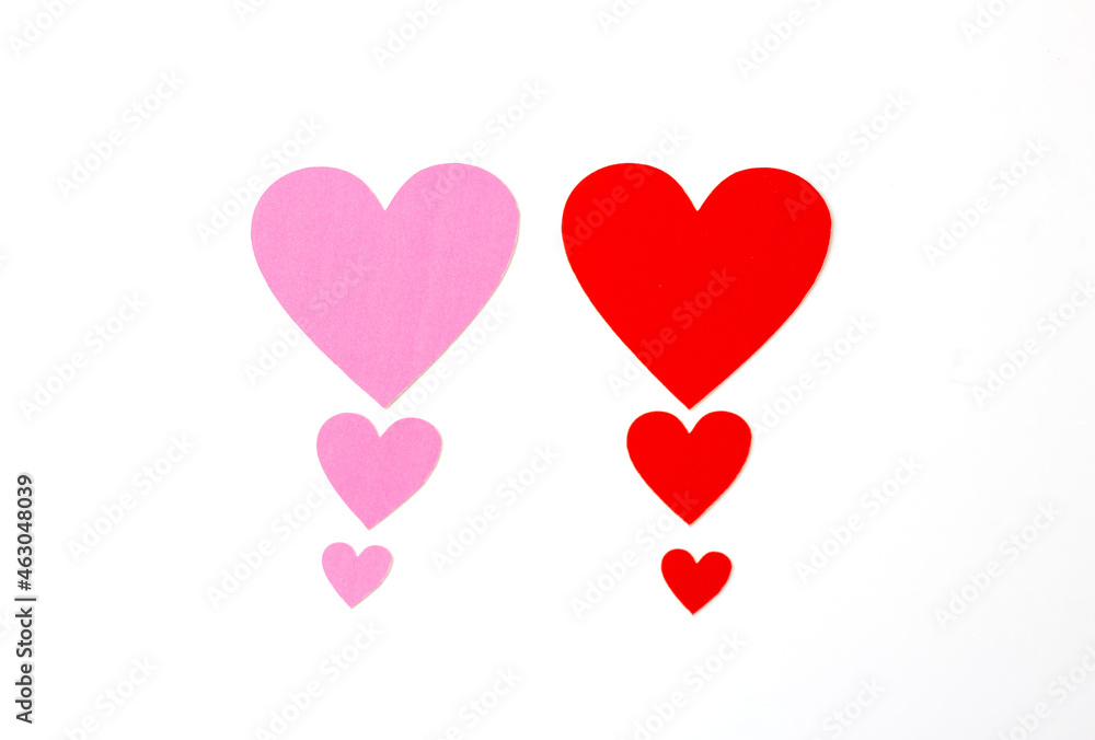 Red and pink heart graded from small to large isolated on a white background.