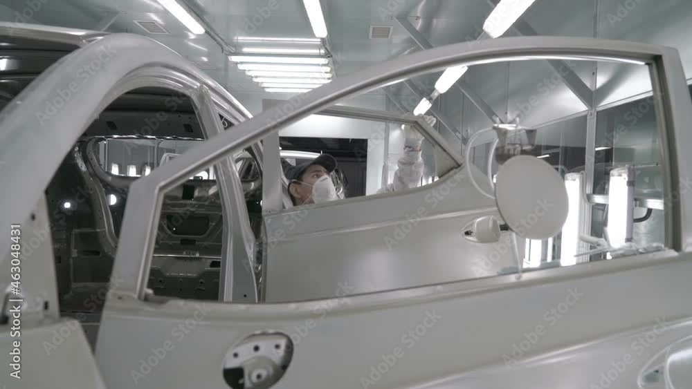 Checkman are checking assembling of car bodies before painting process. Car manufacturing factory. Checkman are checking assembling of car bodies before painting process. Car manufacturing factory.