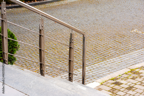 Closeup modern flat stainless railing on outdoor building.