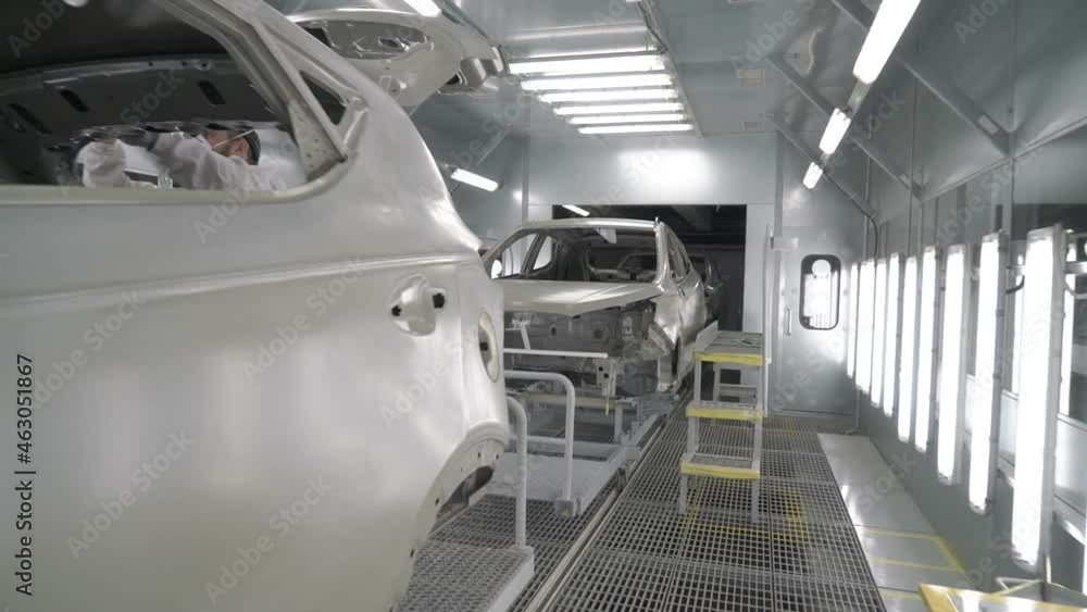 Checkman are checking assembling of car bodies before painting process ...