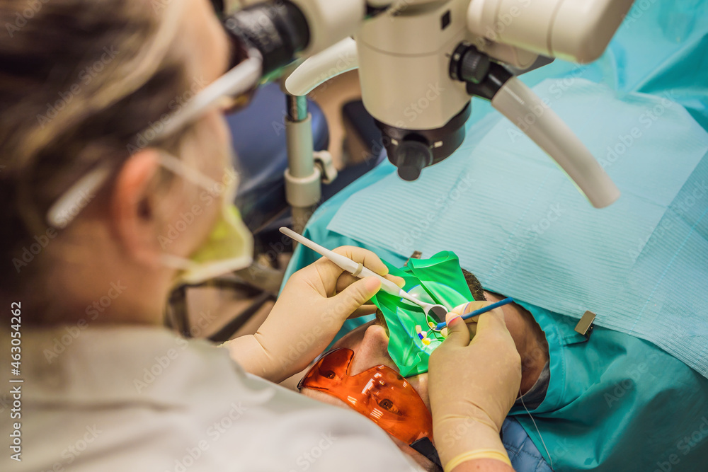 Dental treatment with a microscope. Man having teeth examined at dentists. Appointment at the dentist. lifestyle, real life