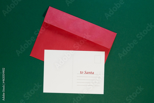 envelope with Christmas letter postcard on green background