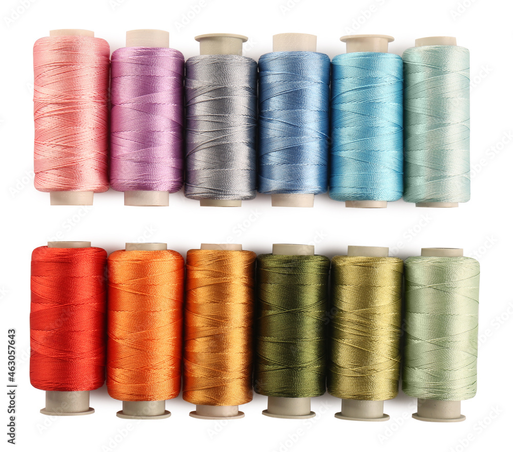 Set of colorful sewing threads on white background, top view Set of colorful sewing threads on white background, top view