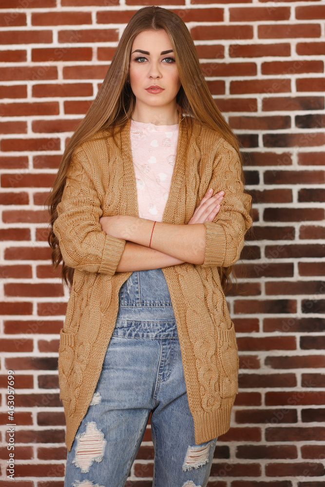Young beautiful woman in jeans and cardigan