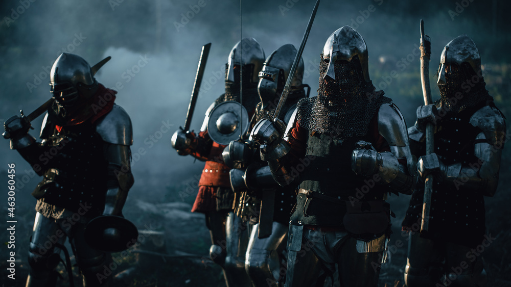 Naklejka premium Epic Invading Army of Medieval Soldiers Marching Through Forest. Armored Warriors with Swords on a Kill and Destroy Mission. War, Battle, Invasion, Conquest. Cinematic Historical Reenactment