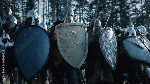 Εκτύπωση καμβά Epic Invading Army of Medieval Knights on Battlefield, Plate Body Armored Soldiers Hit Shields with Swords in Battle Cry
