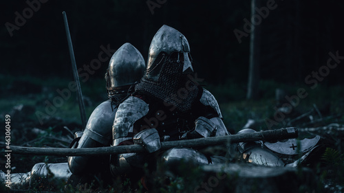 Obraz na plátne Two Medieval Knights Sitting on Battlefield amidst Dead Enemies