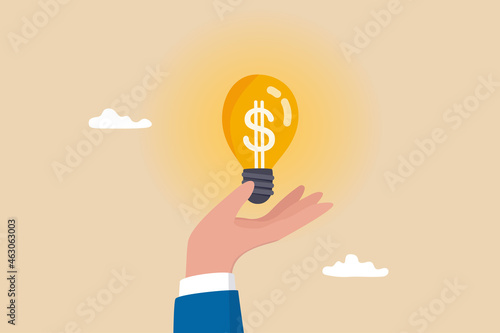 Enlighten money idea, investment and savings with high profit, business idea to make money or profit, innovation or creativity concept, businessman hand hold brightly lit money dollar lightbulb idea. photo