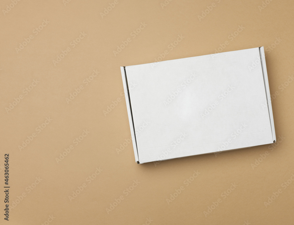 DNN_8585white paper rectangular box on beige background, top view DNN_8585white paper rectangular box on beige background, top view