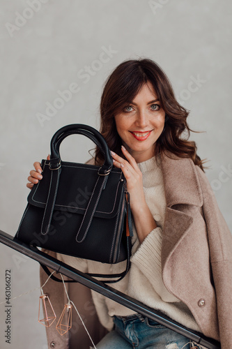 Multi-colored women's bags, photo in a colored interior and in the hands and shoulder of the girl. natural light