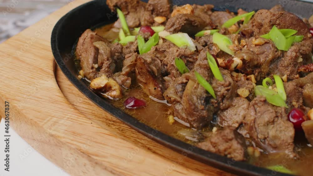 Beef stew in frying pan on table, close up view Beef stew in frying pan on table, close up view