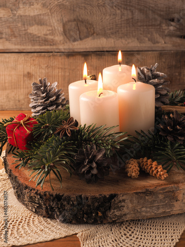 Fourth Advent candle burning, traditional Christmas decoration