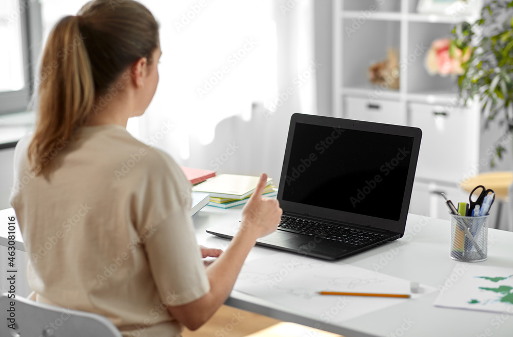 education, online school and distant learning concept - student woman with laptop computer and pencil drawing showing thumbs up at home education, online school and distant learning concept - student woman with laptop computer and pencil drawing showing thumbs up at home