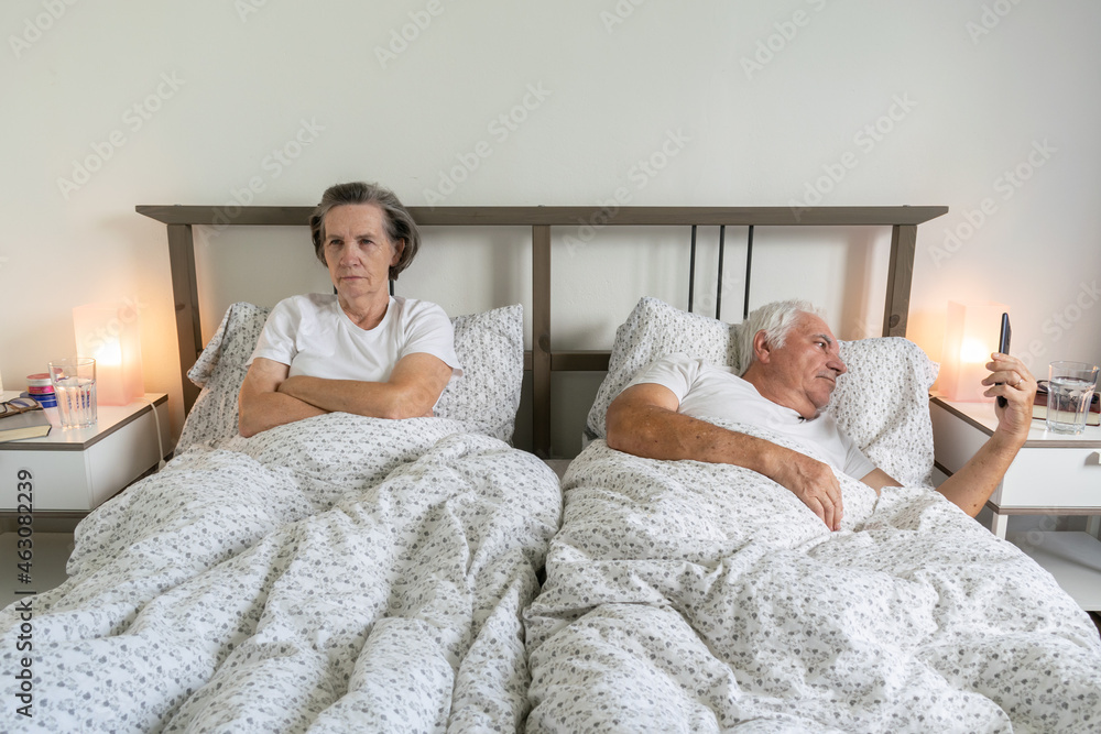 senior aging married couple man male and female woman sleep together in bed sexual problems dysfunction mad angry senior aging married couple man male and female woman sleep together in bed sexual problems dysfunction mad angry