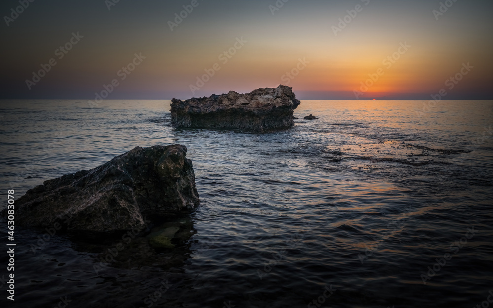 Beautiful sunrise over the rocky coast of the Mediterranean sea
