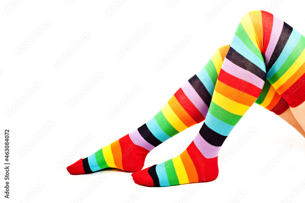 legs of a woman with colorful raibow high socks legs of a woman with colorful raibow high socks