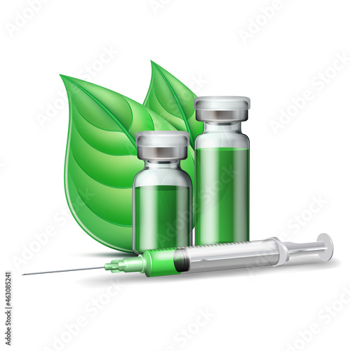 Medical syringe with green liquid and medicine ampoules and vials with green leaves.