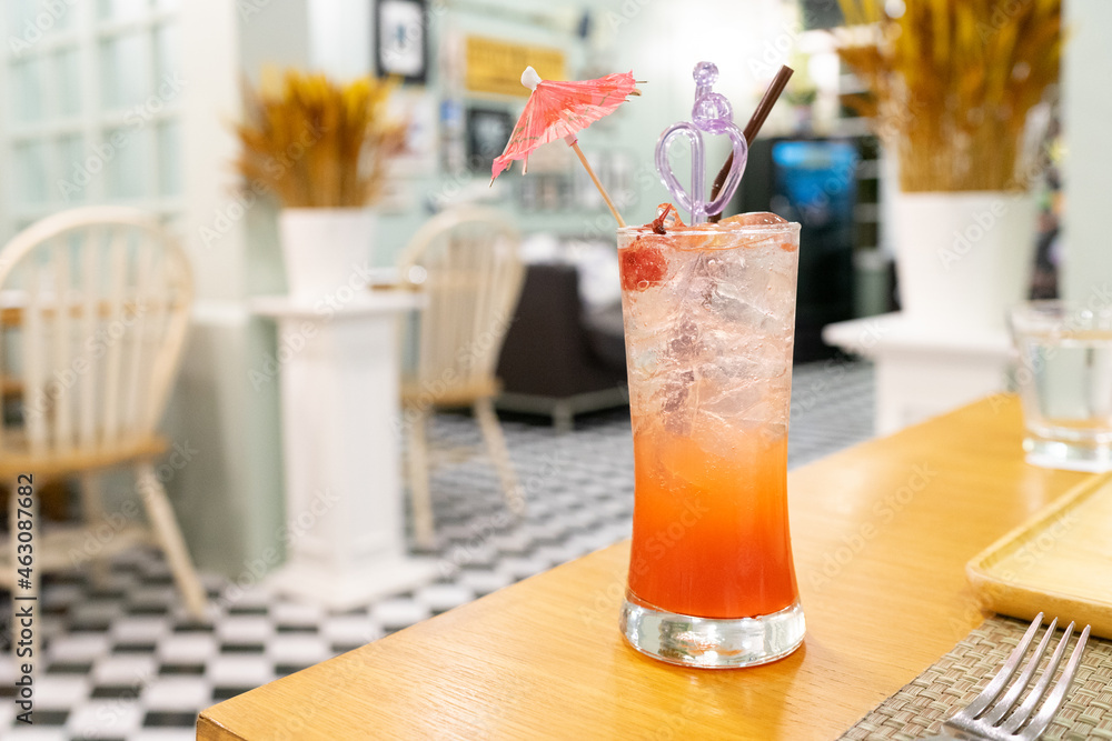 Punch soda on wooden table with restaurant background Punch soda on wooden table with restaurant background