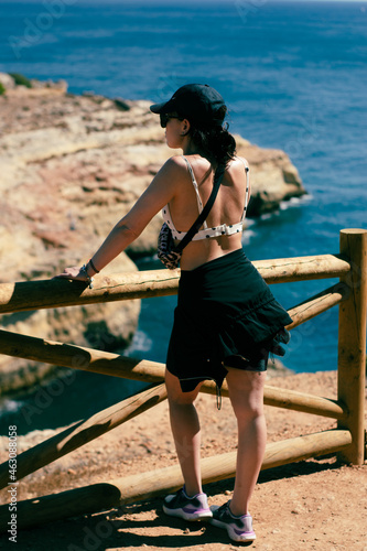 young girl posing on cliff in bikini