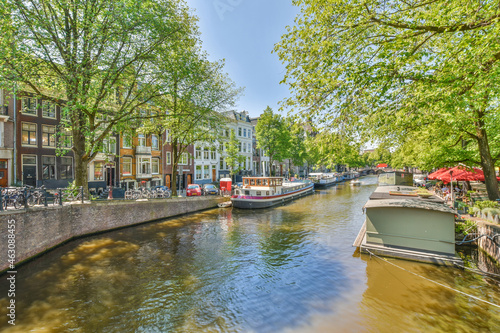 River with motor ships against urban house facades