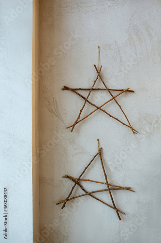 Wooden star  hanging on the wall. New Year s decoration. 2022. 