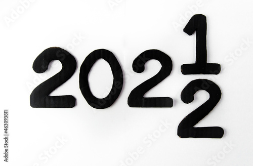 The number from 2021 to 2022 on the asphalt road surface with arrow marking lines, the concept of a happy new year