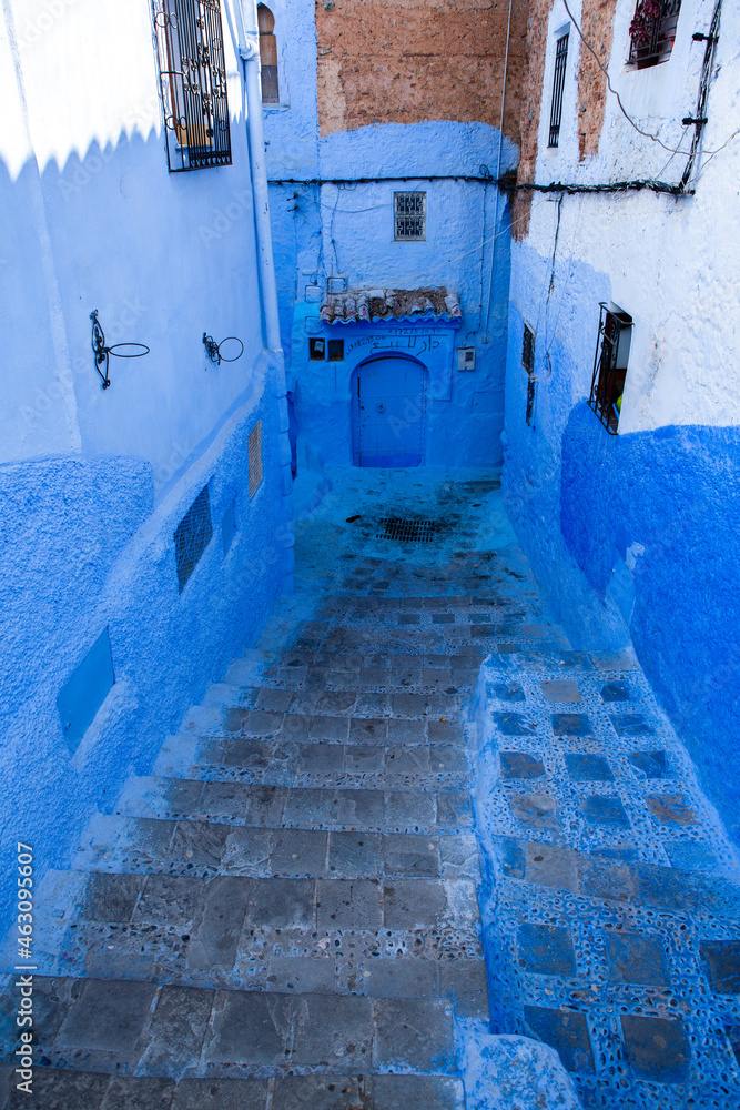 Chefchaouen, Morocco - 6 October, 2021: Blue street and houses in Chefchaouen, Morocco. Beautiful colored medieval street painted in soft blue color. Chefchaouen, Morocco - 6 October, 2021: Blue street and houses in Chefchaouen, Morocco. Beautiful colored medieval street painted in soft blue color.