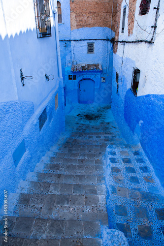 Chefchaouen, Morocco - 6 October, 2021: Blue street and houses in Chefchaouen, Morocco. Beautiful colored medieval street painted in soft blue color. © romeof