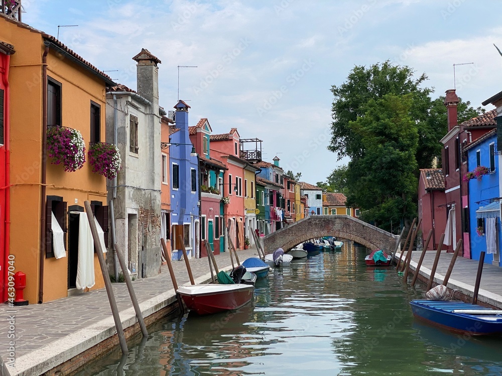 Boats and colorful traditional painted houses in a canal street houses of Burano island, Venice, Italy
