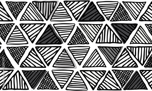 Doodled tribal pattern in monochrome colors. This updated tribal motif features hand-drawn triangles in a repeating pattern.