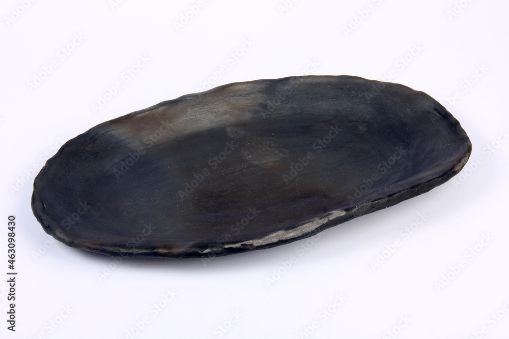 black clay plate on a white background