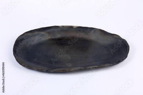 black clay plate on a white background © SHARKY PHOTOGRAPHY
