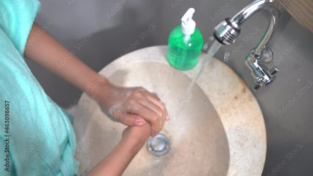 close up of girls hands washing hands with running water close up of girls hands washing hands with running water
