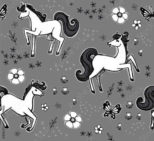 Monochrome scene featuring horses and flowers in a seamless vector pattern. These hand-drawn ponies frolic and play in a black and white color scheme. 